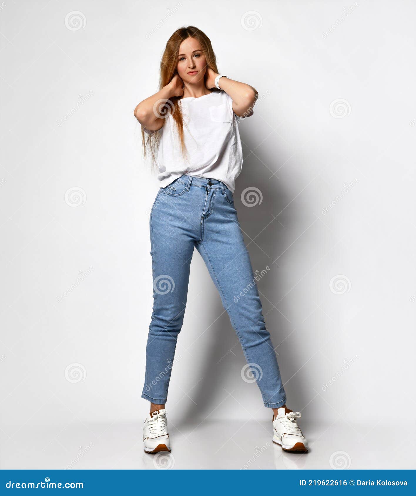 Pretty Stylish Brunette Girl In Blue Jeans And White Blouse Posing In  Summer Park Background Stock Photo, Picture and Royalty Free Image. Image  130042578.