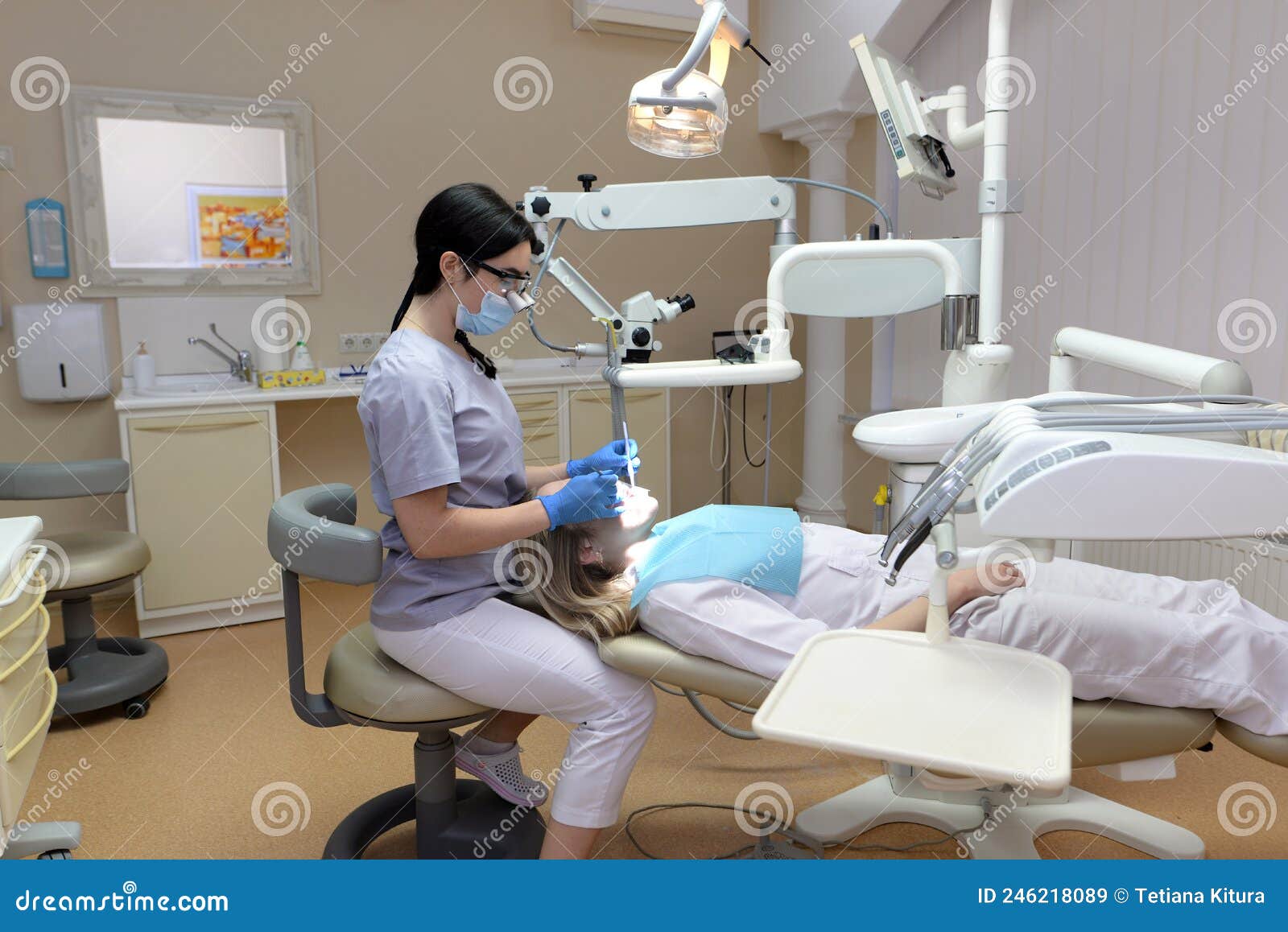 Stomatologist Examining Teeth of Patient with Help of Professional