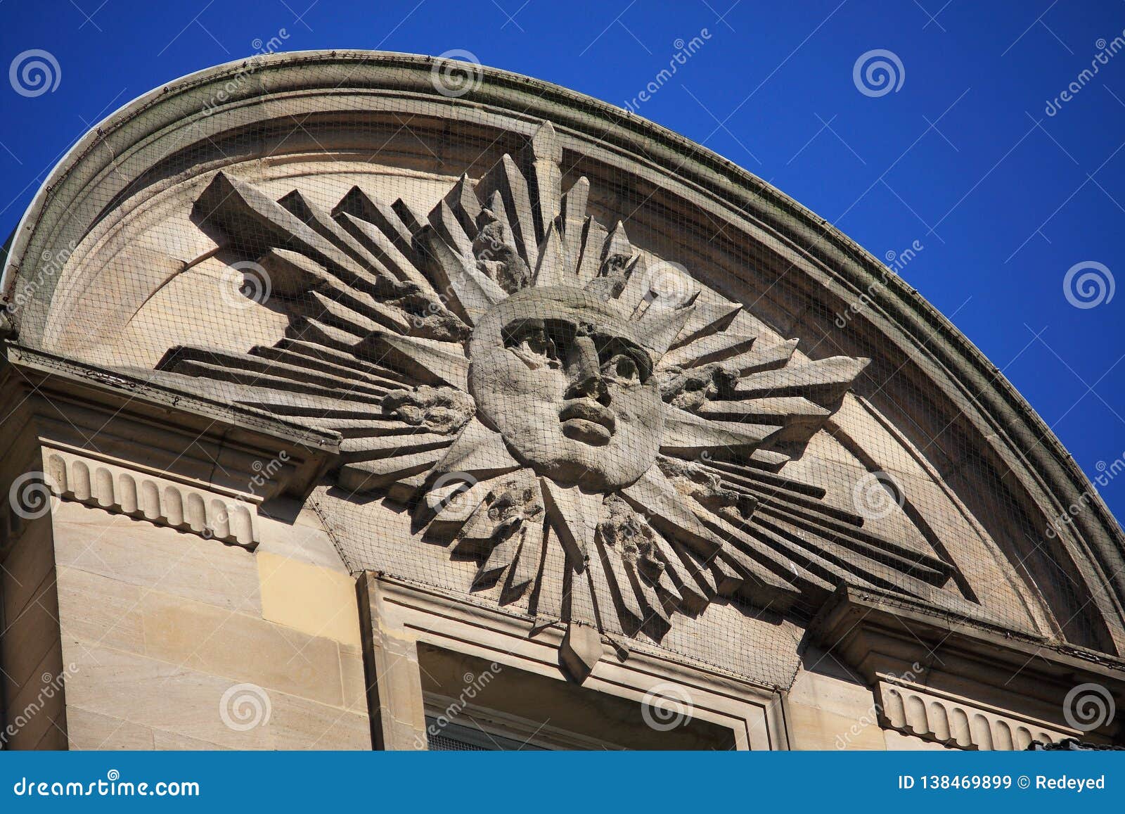 masonry sunburst and face apex