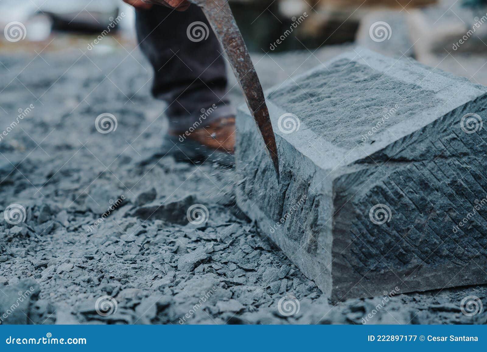 stone craftsman carefully chipping at a block of cancagua stone to  it