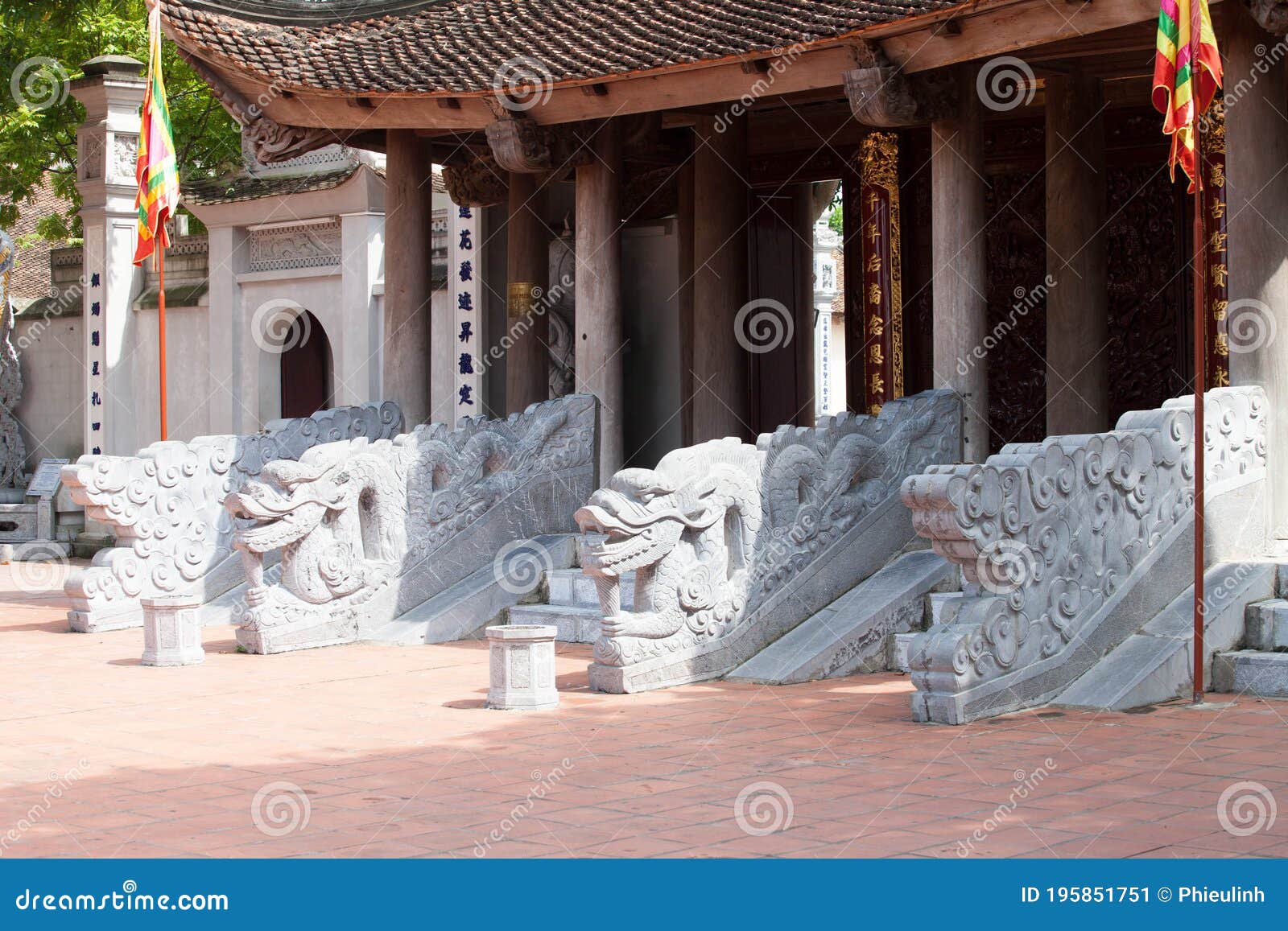 stone dragon statue in vietnam with face close-up on blue sky background. leftside view.  of vietnamese mythology and folklo