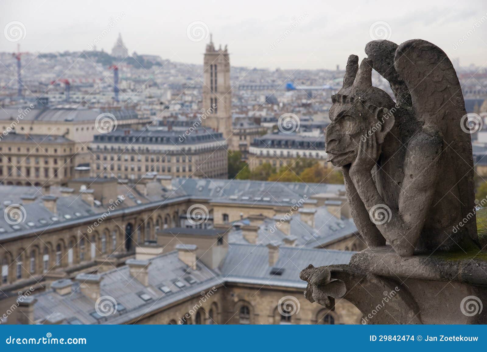 stone gargoyle overlooking paris from the notre dame