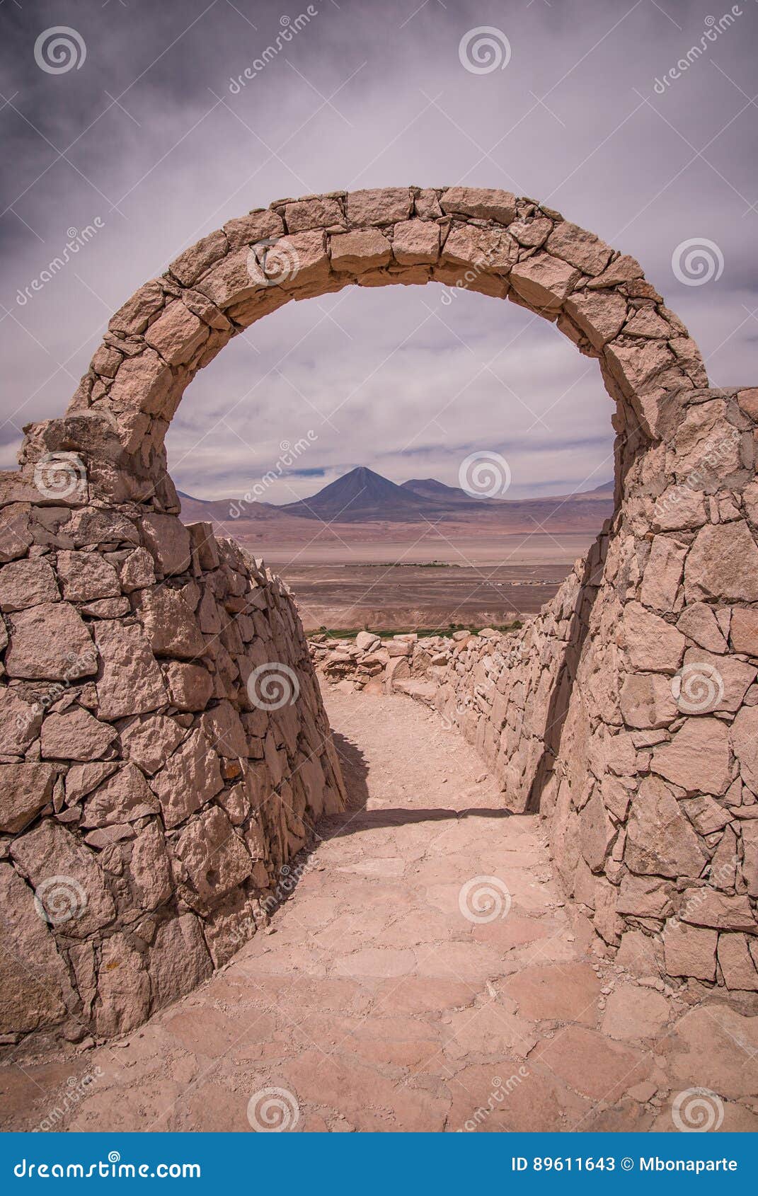 stone gate at pukara de quitor - inca fortress at atacama desert with the view at licancabur volcano in andes, san pedro de atacam