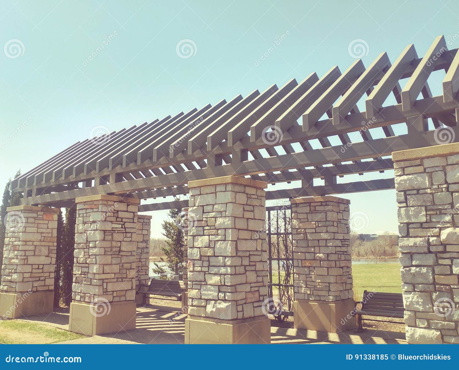 stone pergola in city park in the spring