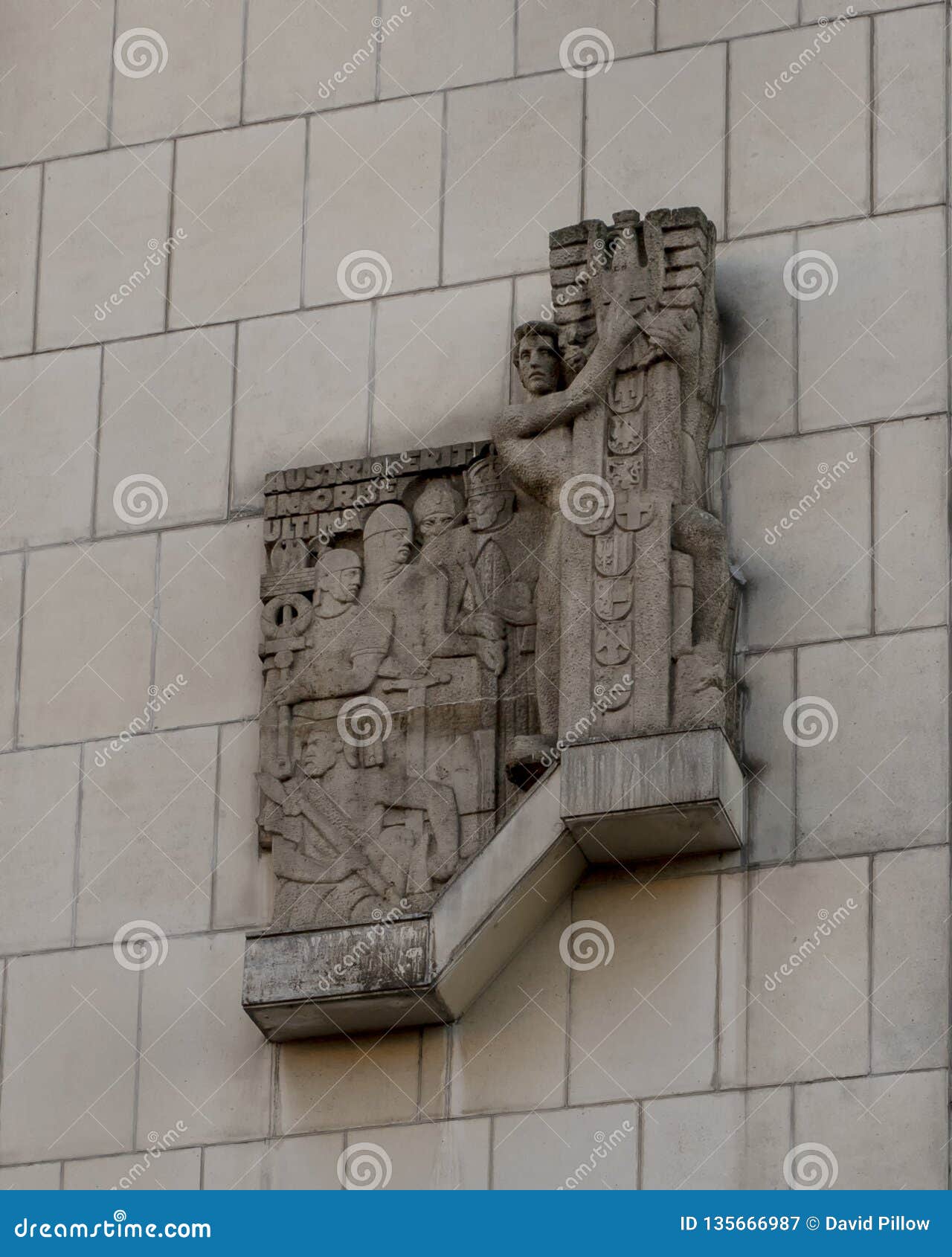 stone relief on wall in vienna, with inscription `austria erit in orbe ultima`.