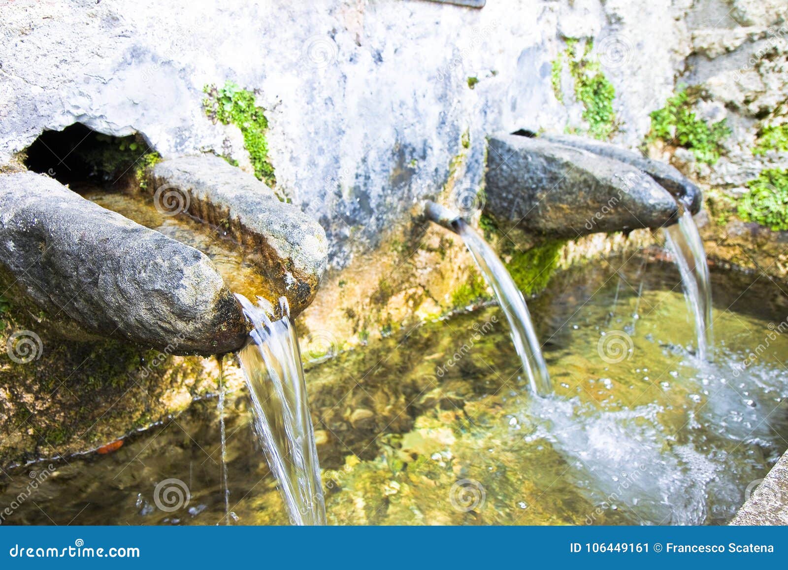 Stone Source of Drinking Water Comes from a Mountain Image Wit Stock