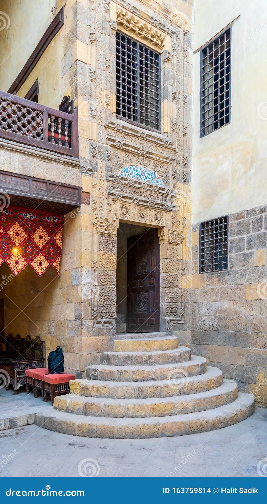 stone staircase and wooden door leading to old mamluk era beit el sennary building, cairo, egypt
