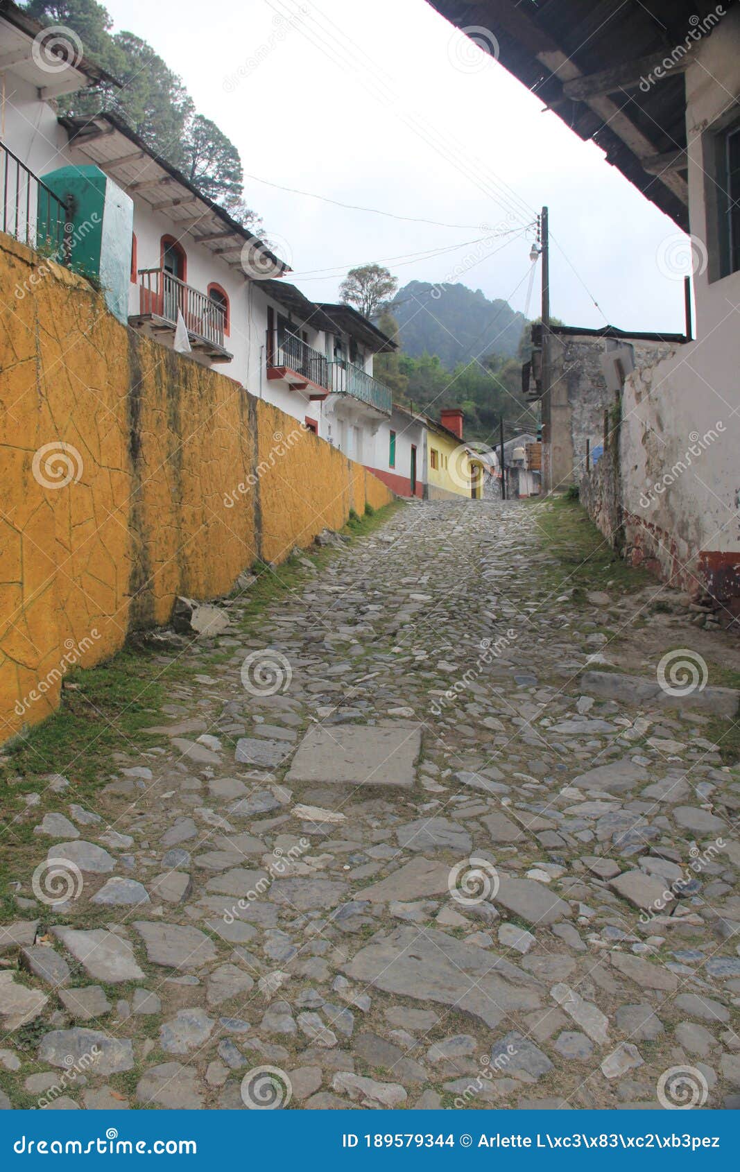 stone street, colorful houses and ruins of the la encarnacion foundry in zimapan hidalgo mexico