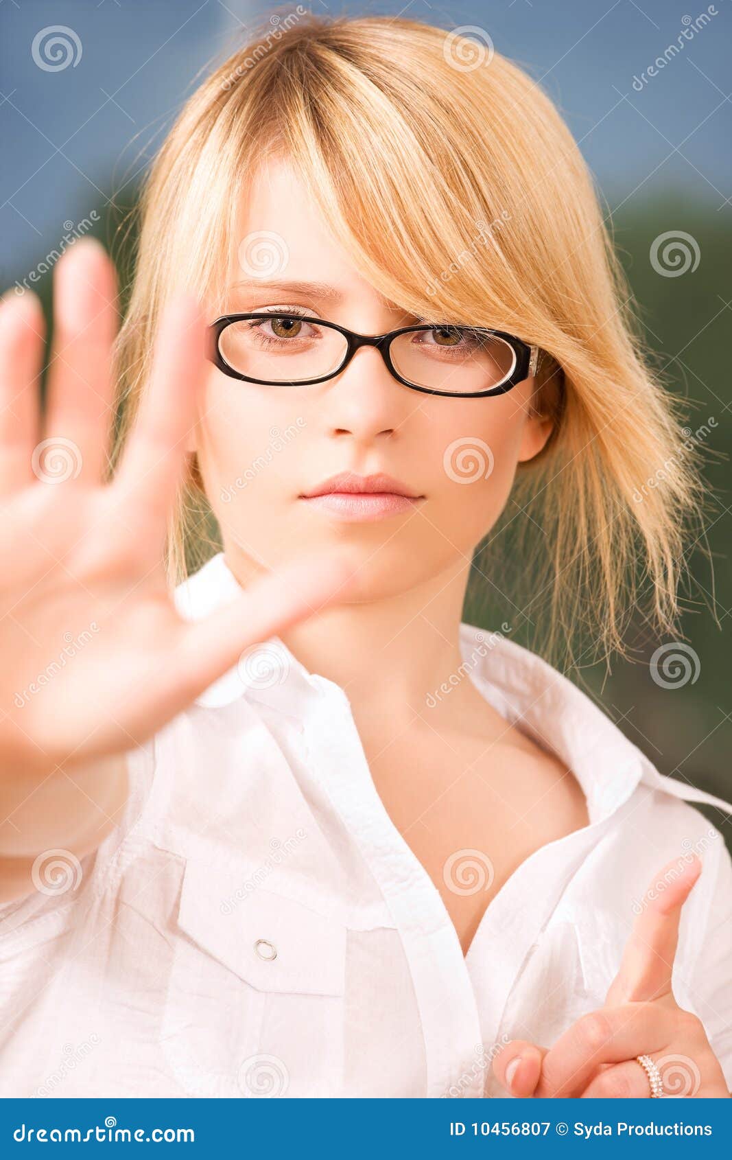 Stop!. Bright picture of young woman making stop gesture