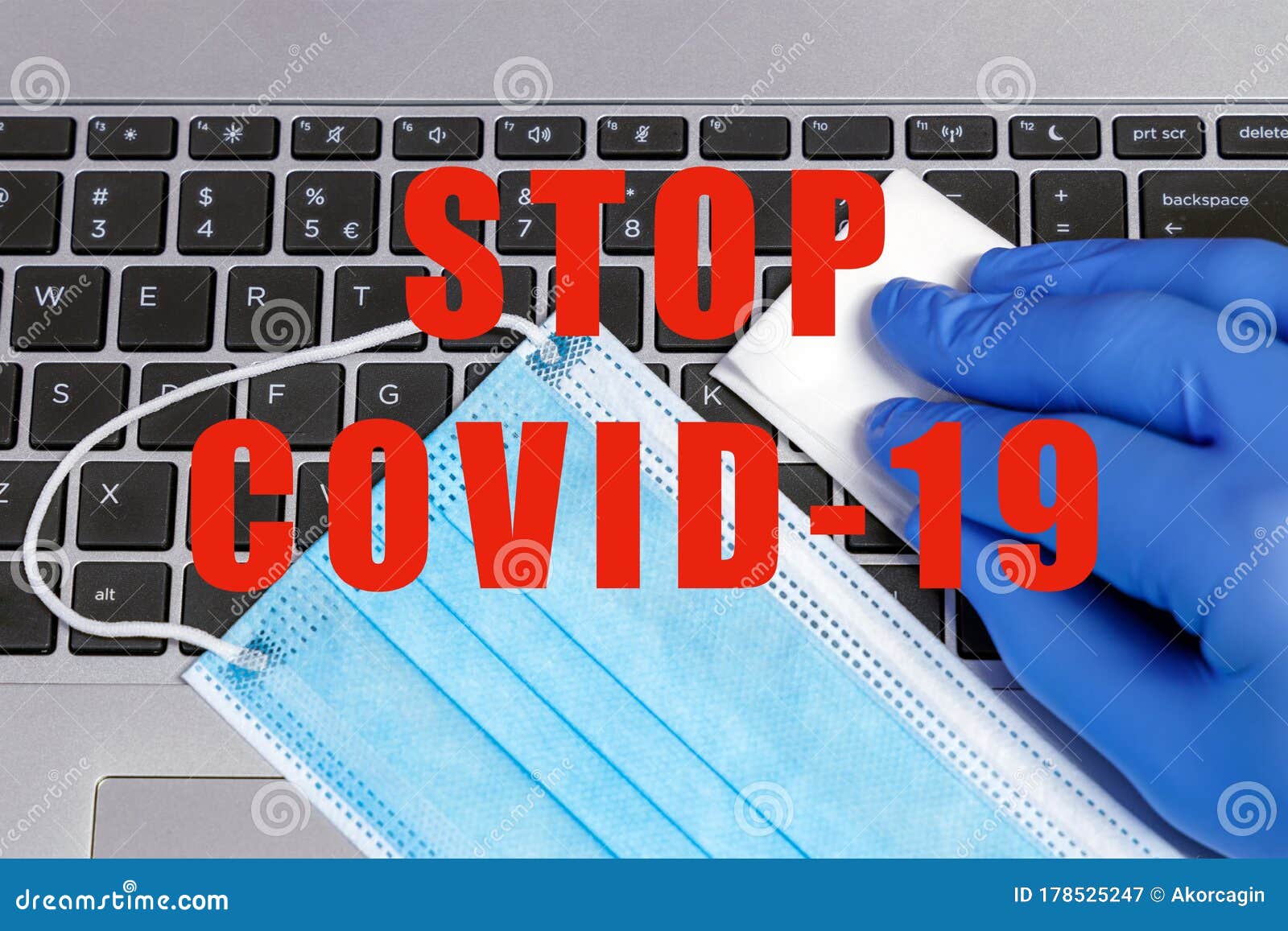 stop covid-19 coronavirus prevention concept disinfection of workspace person cleaning laptop keybord with disinfecting wipes