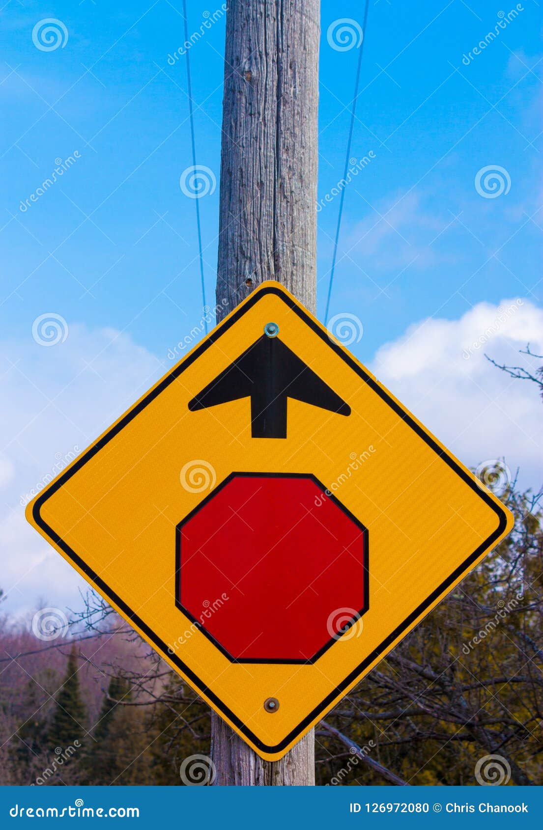 Stop Sign Mounted on Telephone Pole Giving Direction Stock Photo