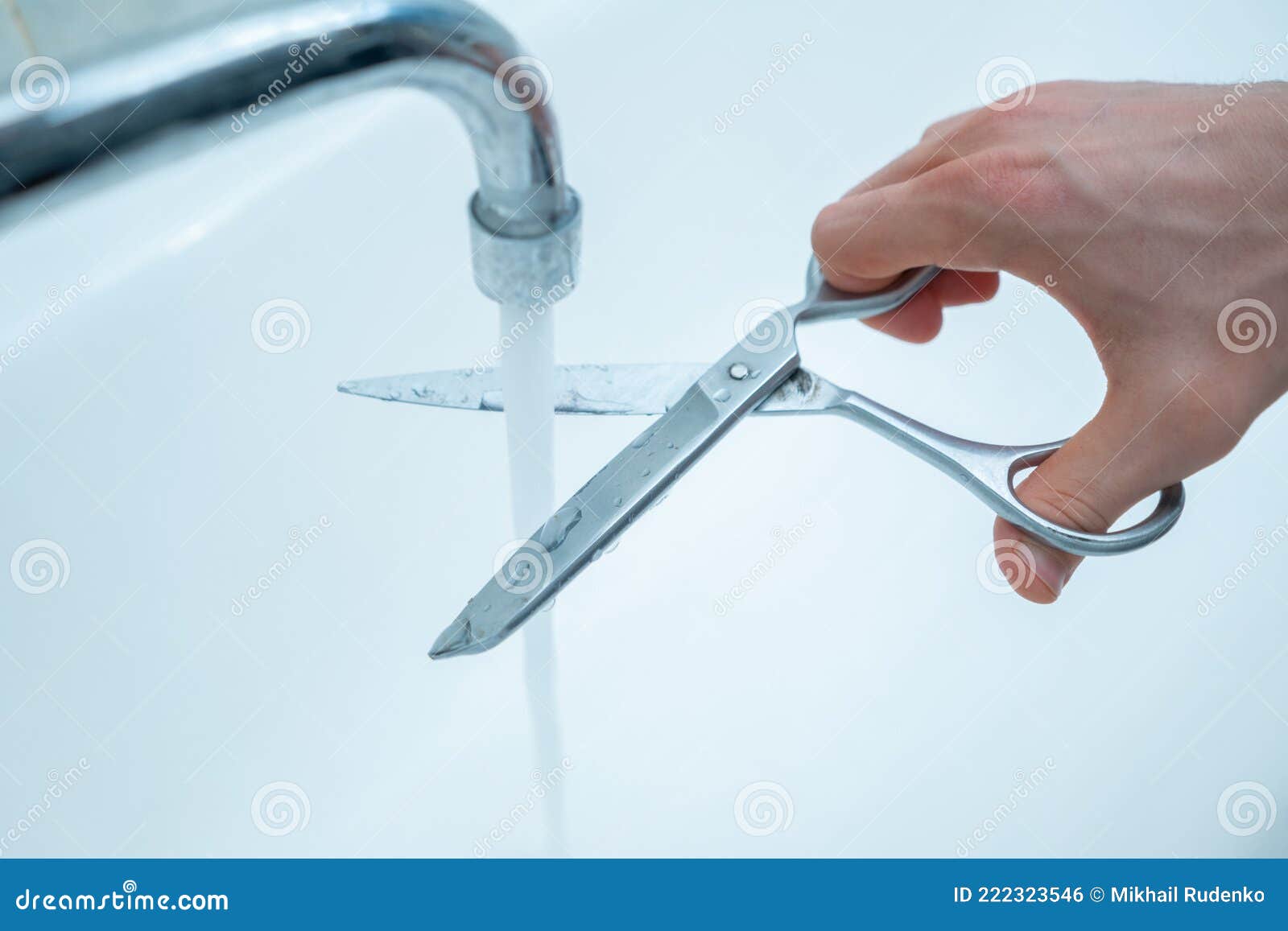 Stop Wasting the Pure Water, Hand with Scissors Cut the Water Stream
