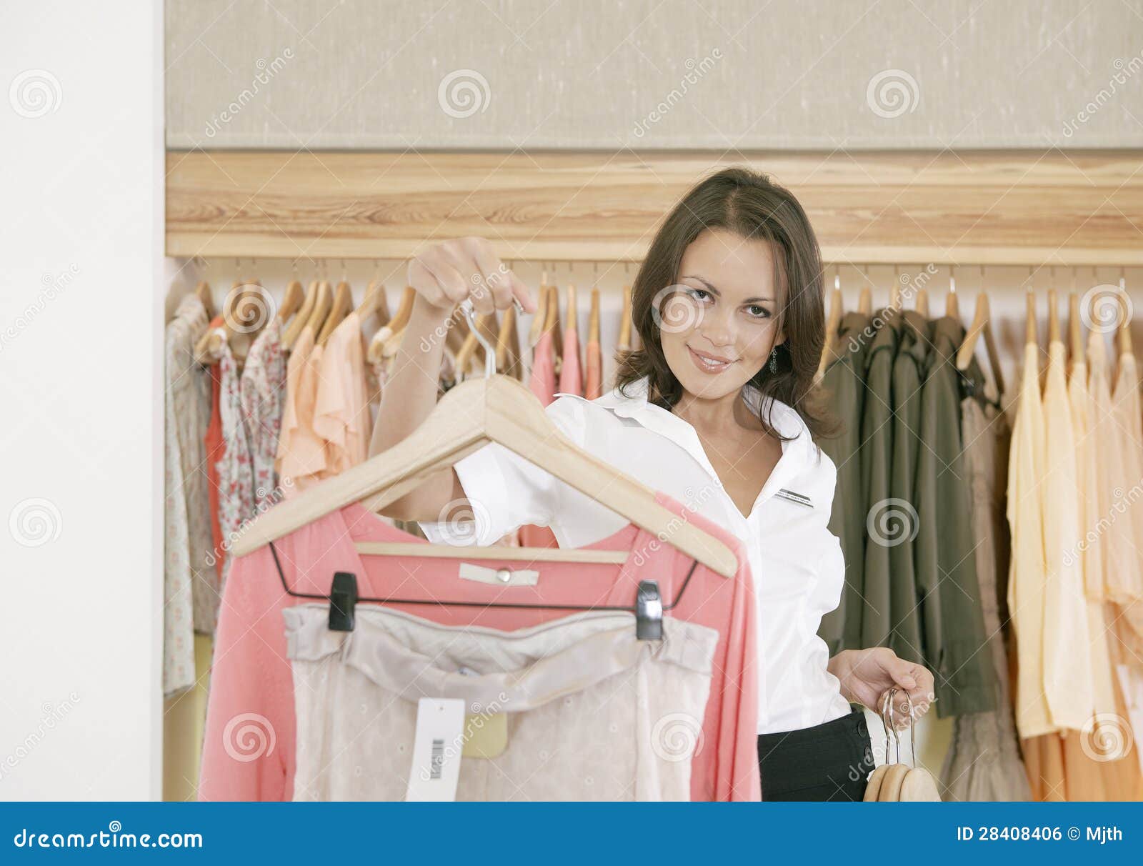 Store Assitant Working and Hanging Clothes in Store Stock Photo Image