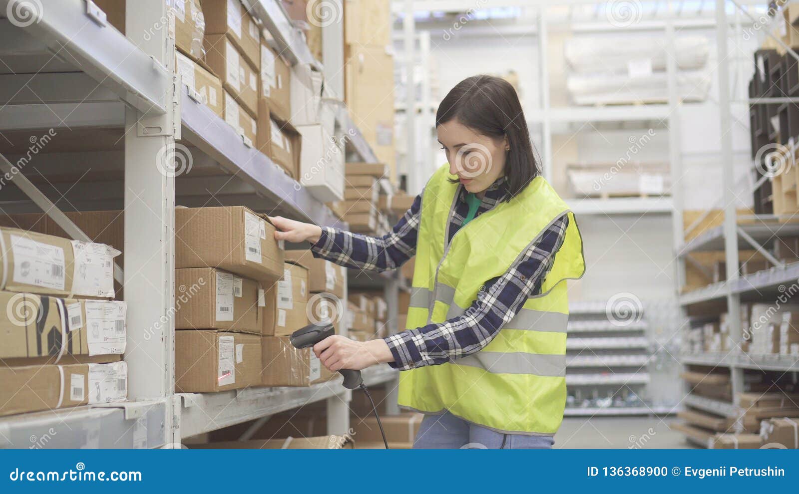 Store Worker in the Warehouse Using a Barcode Scanner Conducts