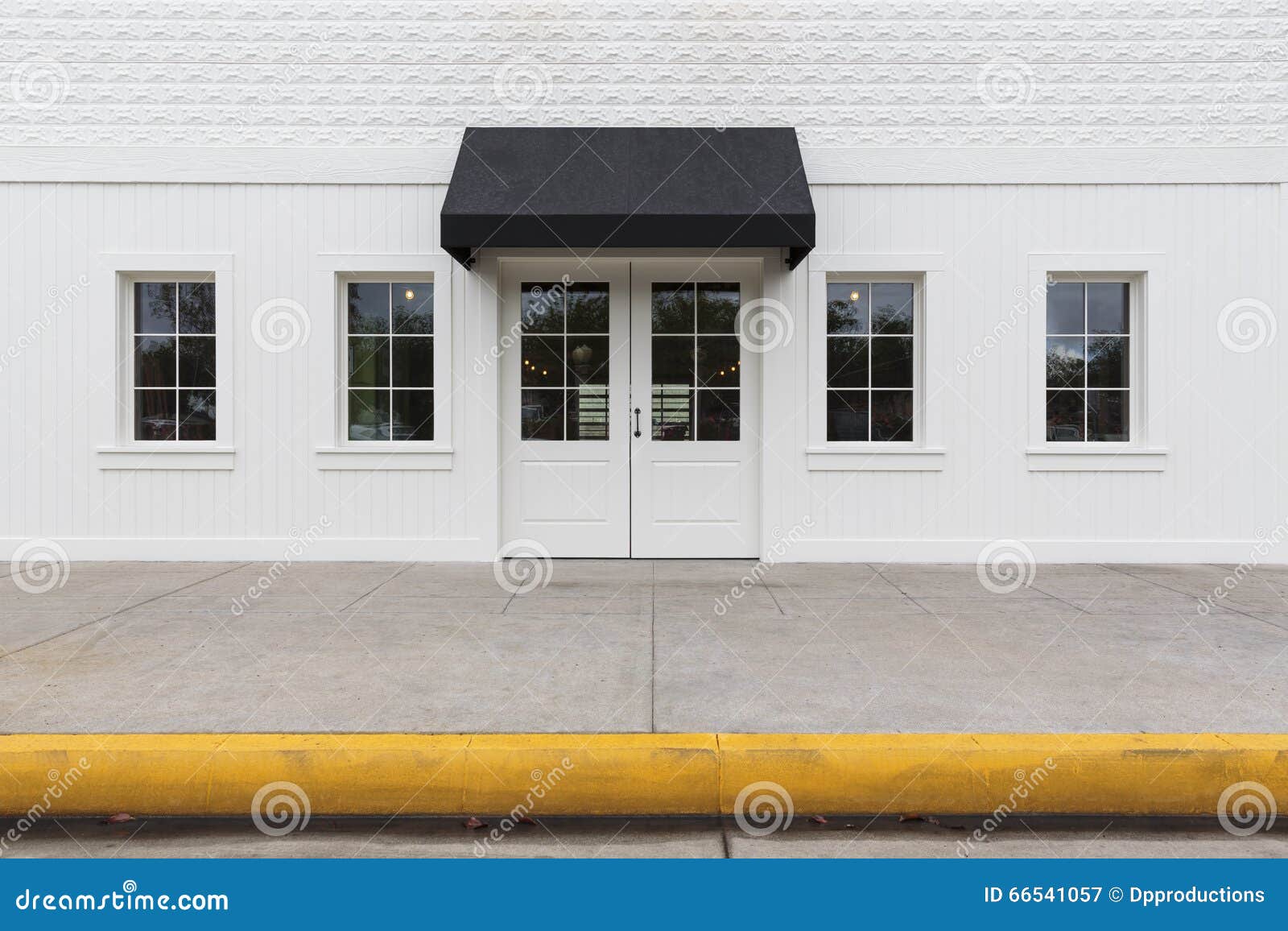 storefront building with black awning