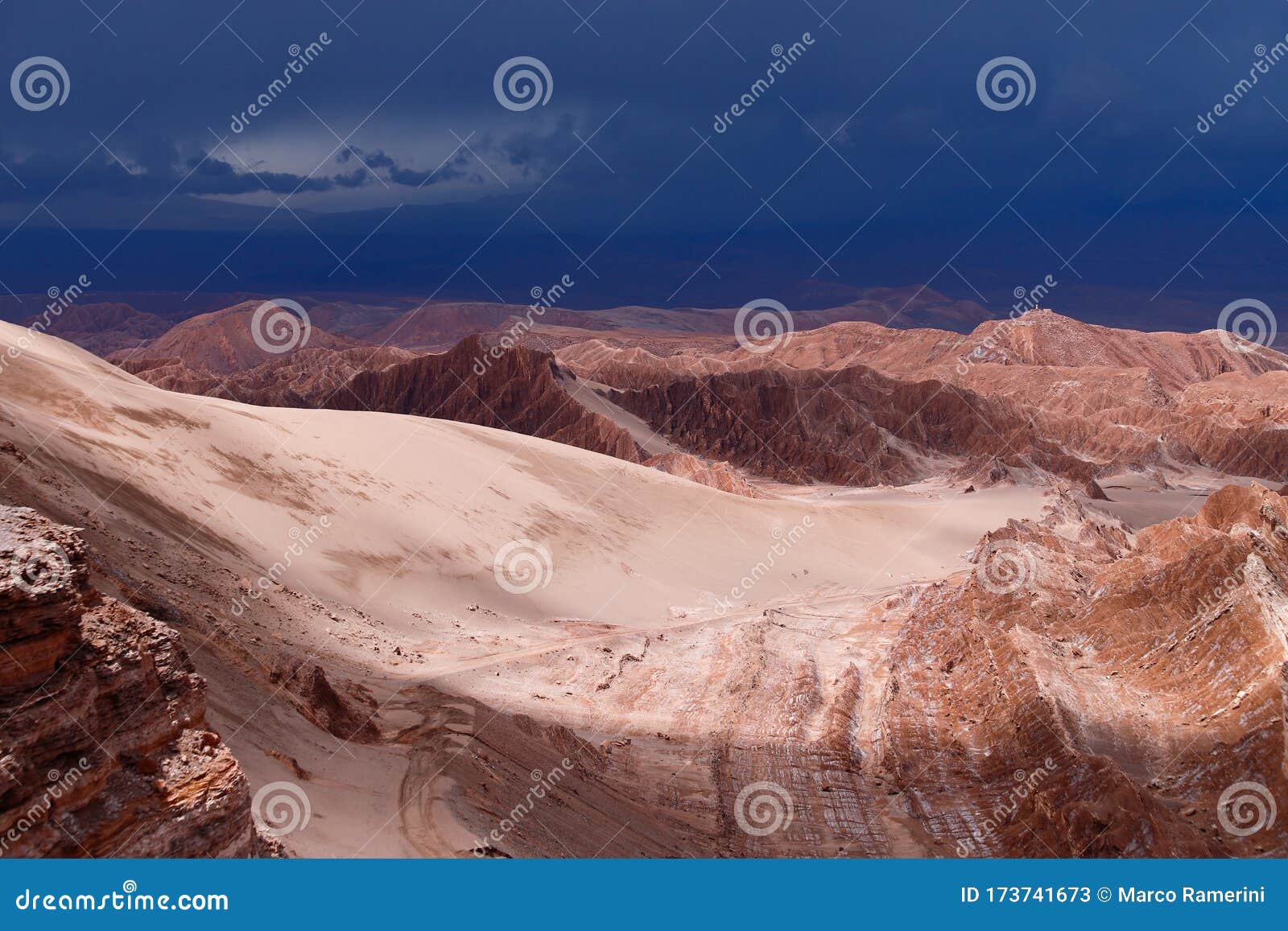 storm clouds in the landscape of the atacama desert. the rocks of the mars valley valle de marte and cordillera de la sal,