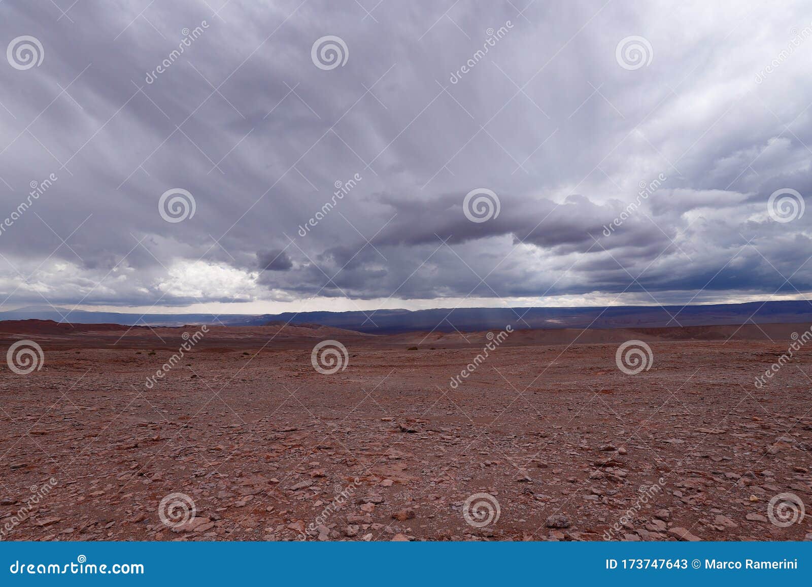 storm clouds in the landscape of the atacama desert. the rocks of the mars valley valle de marte and cordillera de la sal,