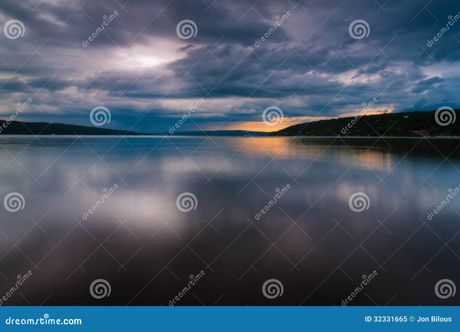storm clouds move over lake cayuga in a long exposure