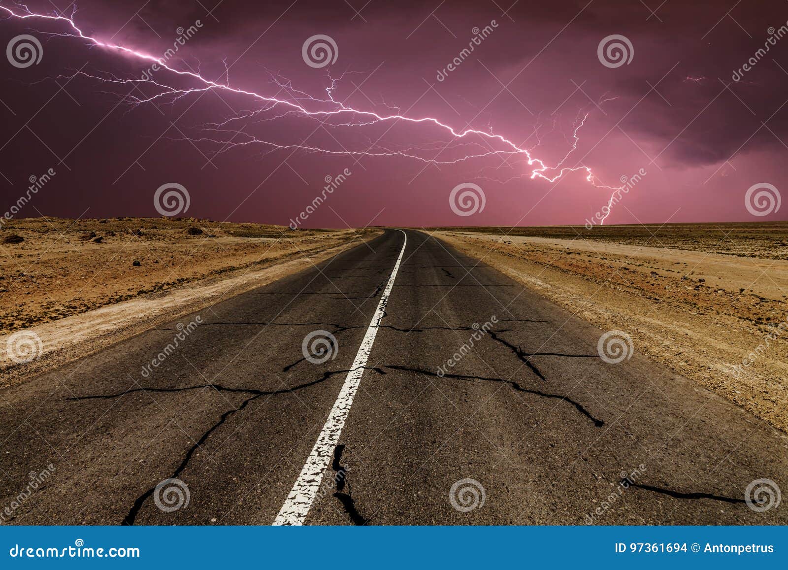 Stormy Country Road at Night, with Intense Lightning Strikes. Stock