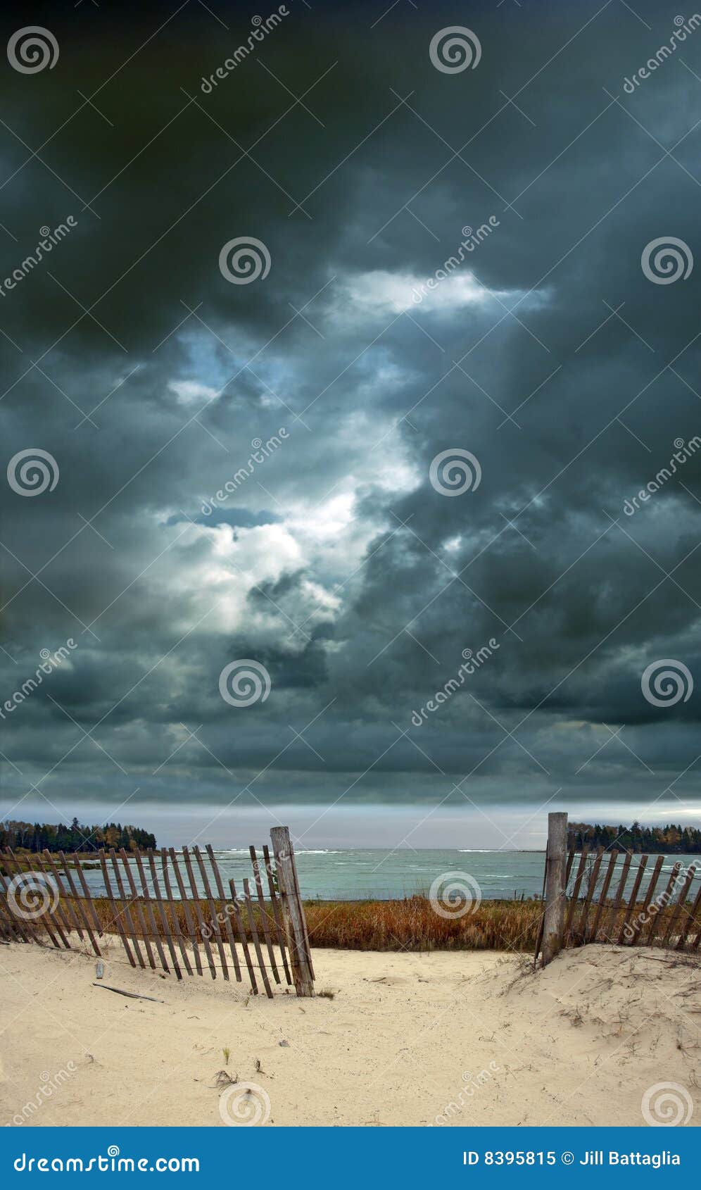 stormy sky at the beach with fence
