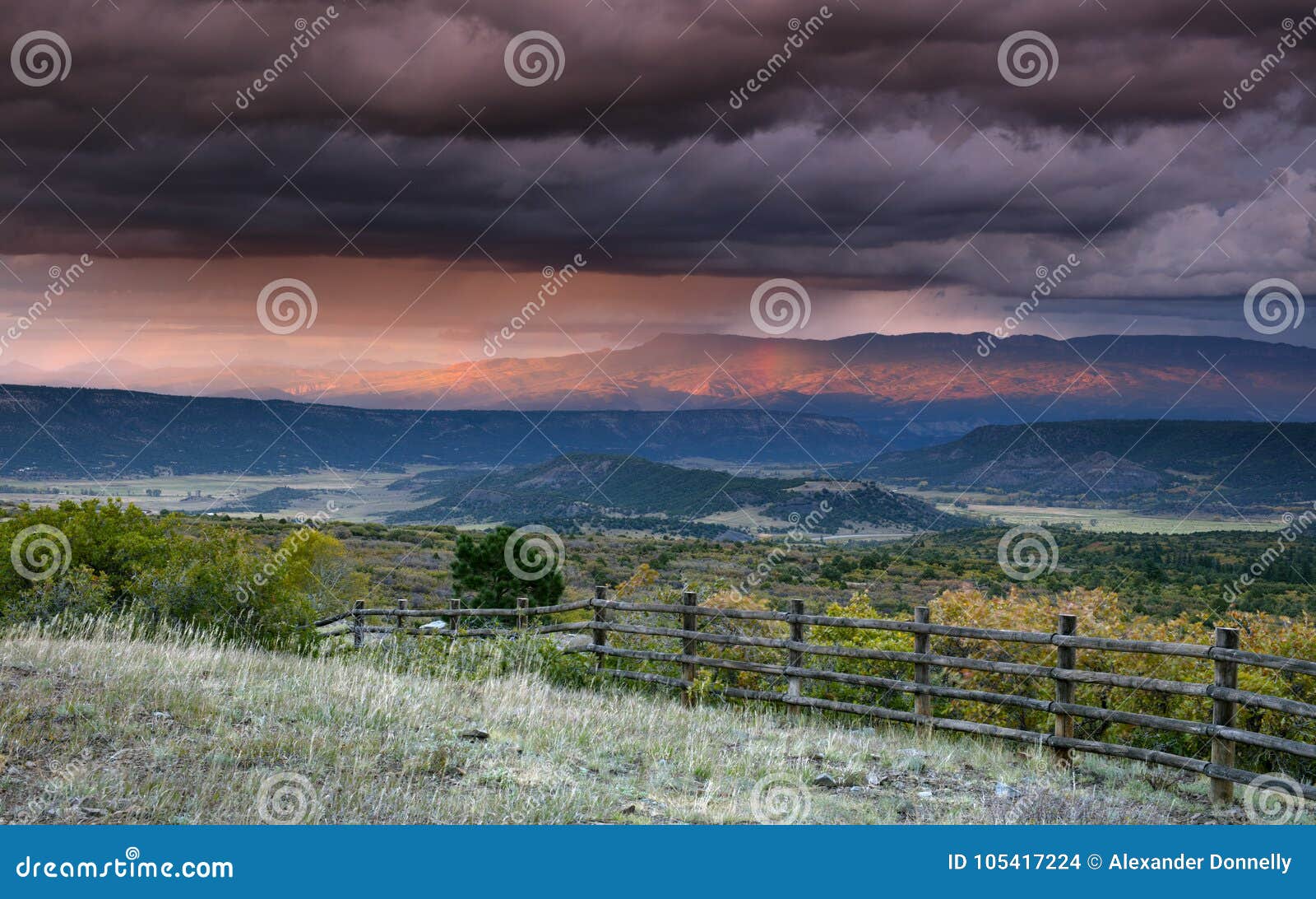 stormy sky at sunset over san juan mountain range and autumn fall color of the dallas divide ridgway colorado