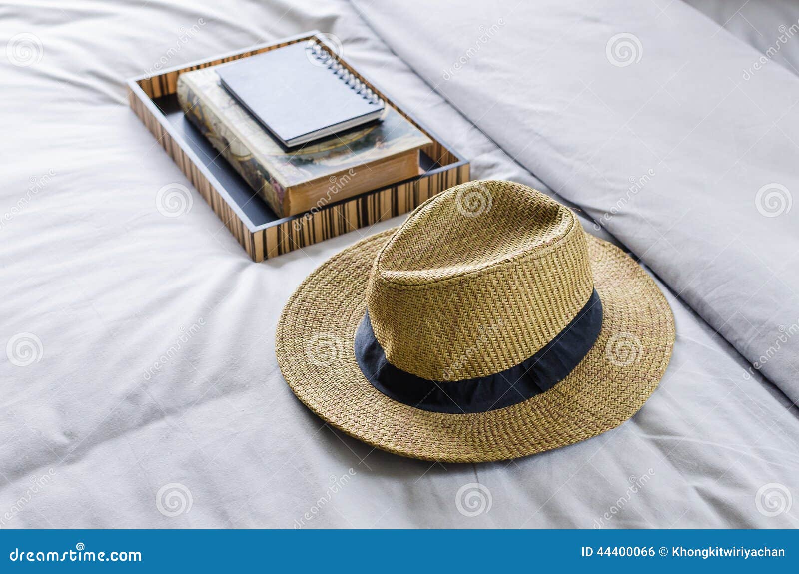 Straw hat on bed stock photo. Image of culture, black 44400066