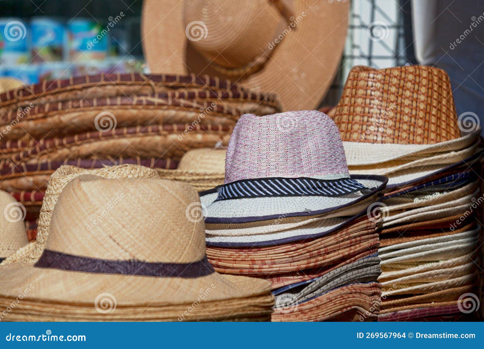 straw hats for sale on a market stall