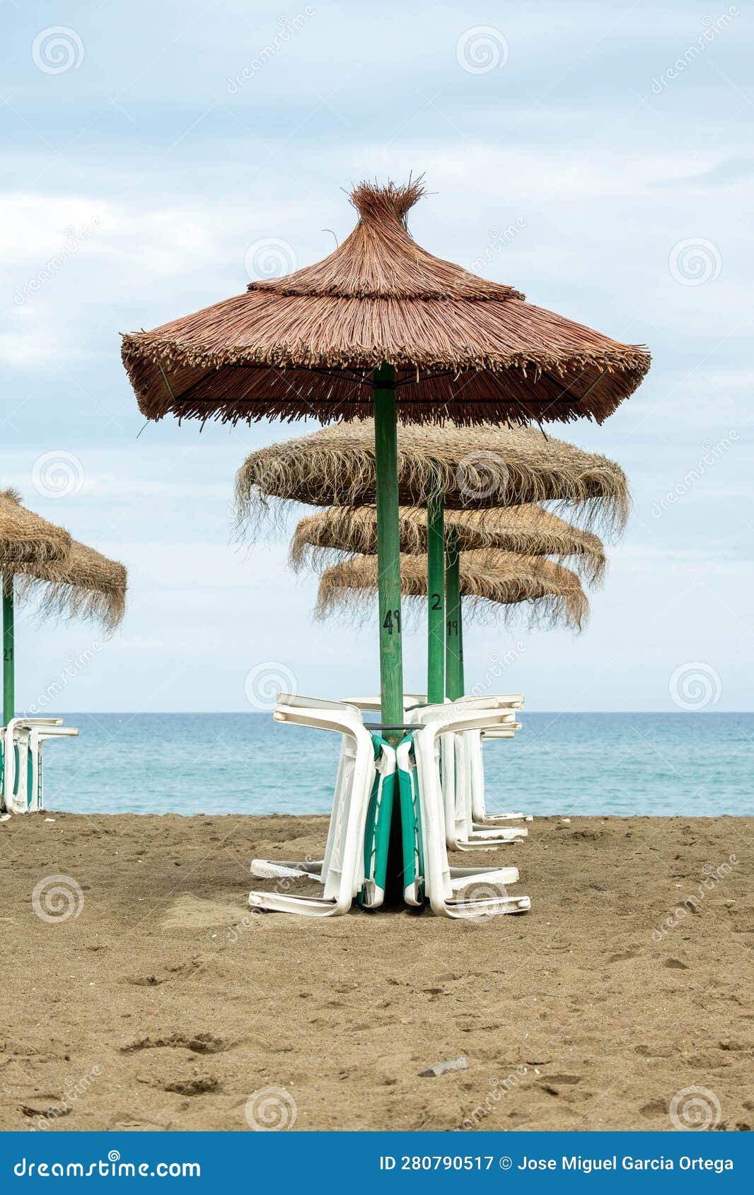 straw umbrellas with sunbeds on the beach