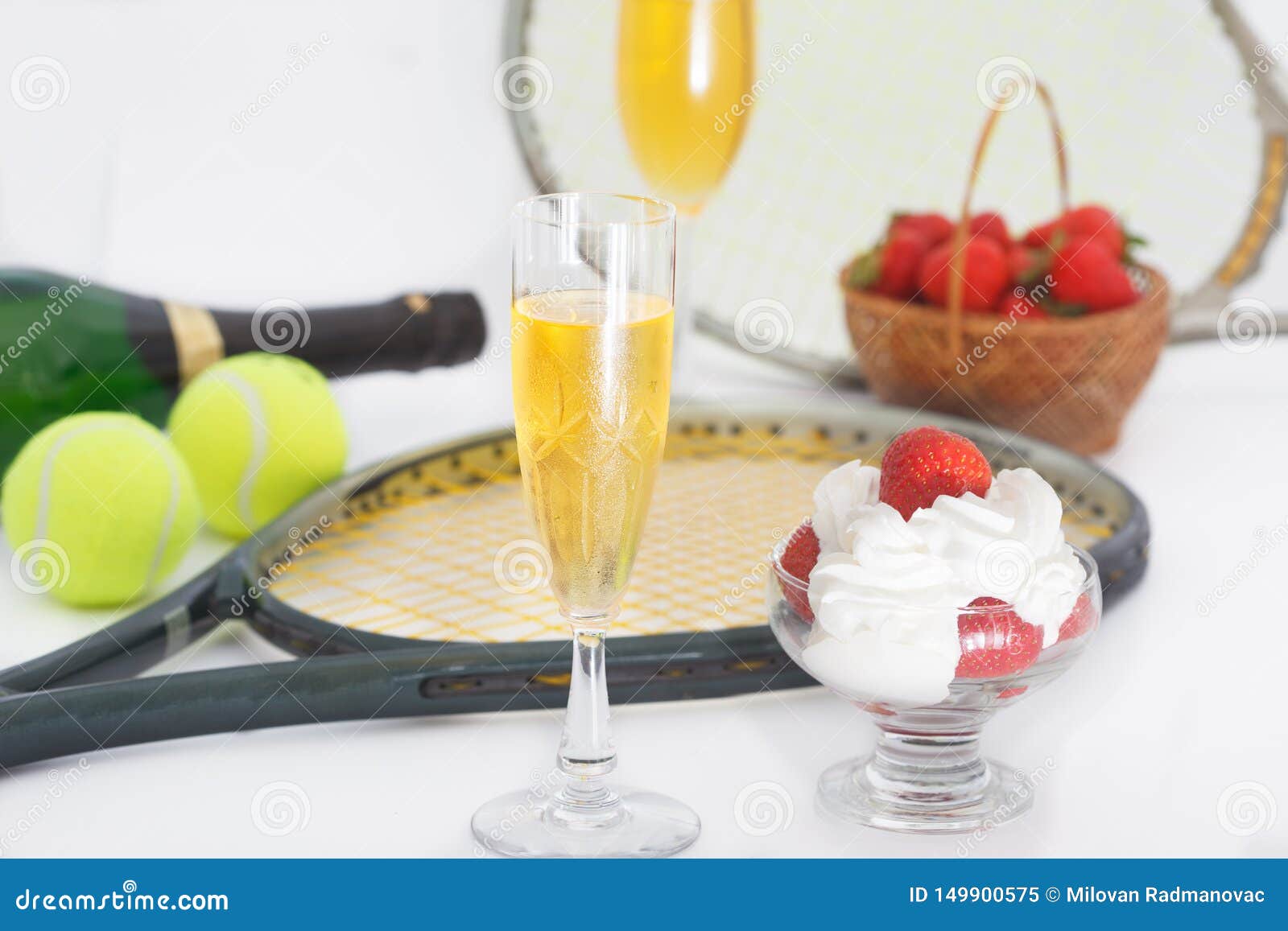 strawberries and champagne with tennis equipment on wimbledon tournament