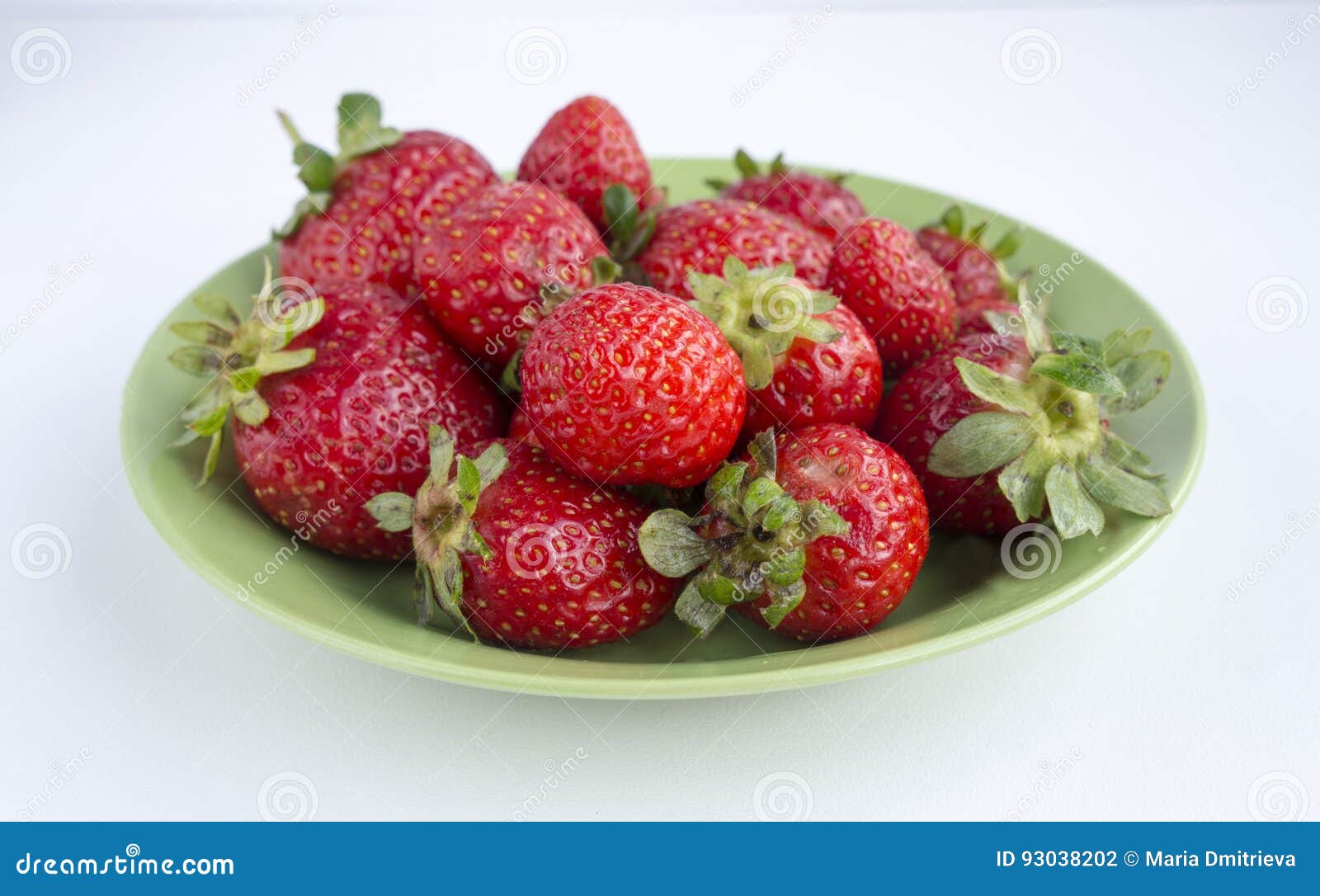 Strawberries on a plate. Strawberries on a green plate; closeup