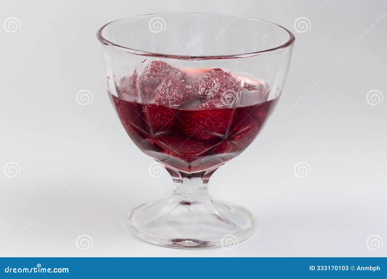 strawberry jam with whole berries in glass dessert bowl