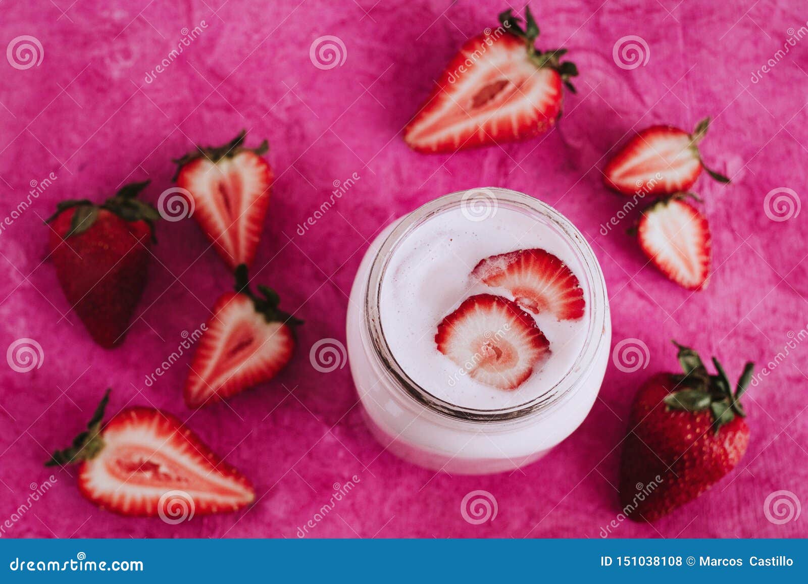 strawberry milkshake in the glass jar pink background
