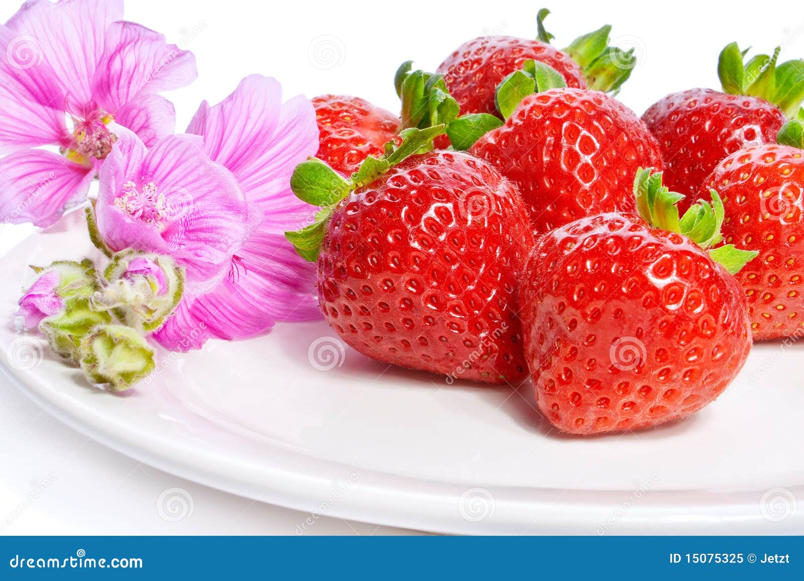 strawberry on a plate decorated with malva flowers