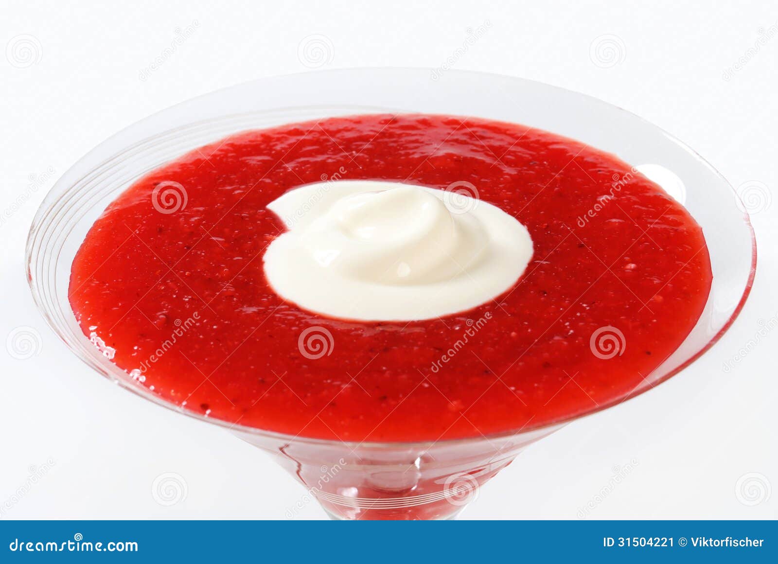 A martini glass filled with a strawberry puree and cream mixture
