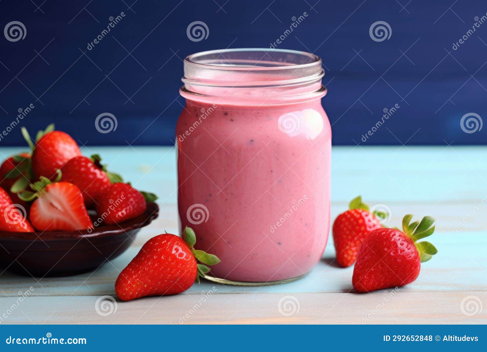 A Strawberry Yogurt Drink in a Clear Bottle with a Blue Cap Stock Photo