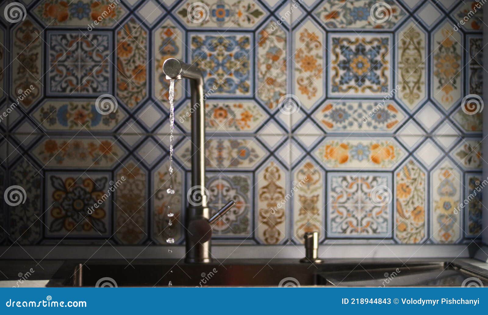 A Stream of Clean Water Flows from the Mixer into the Kitchen Sink