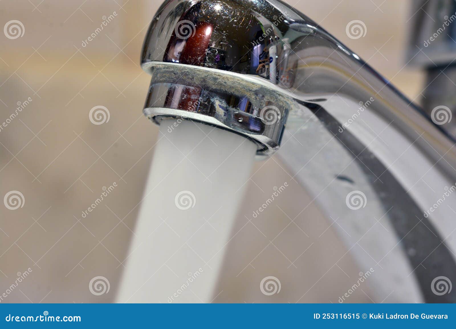 stream of water falling from a faucet in a sink