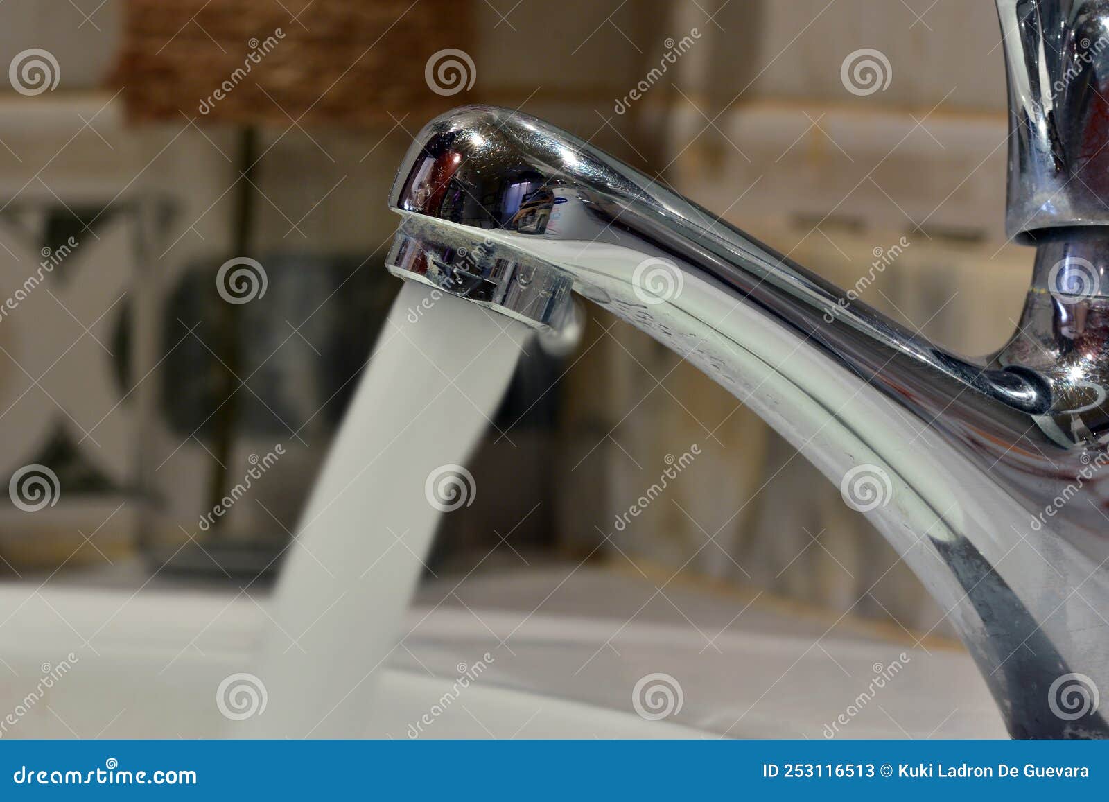 stream of water falling from a faucet in a sink