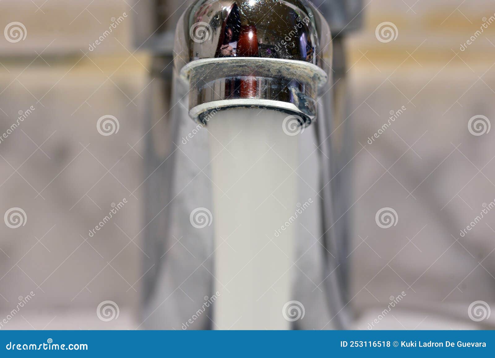 stream of water falling from a faucet in a sink