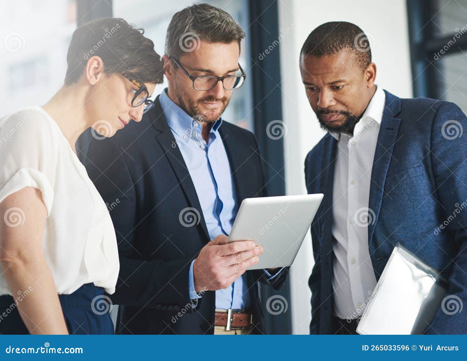 Streamlining Workflow with Teamwork and Wireless Technology. a Team of Colleagues Using a