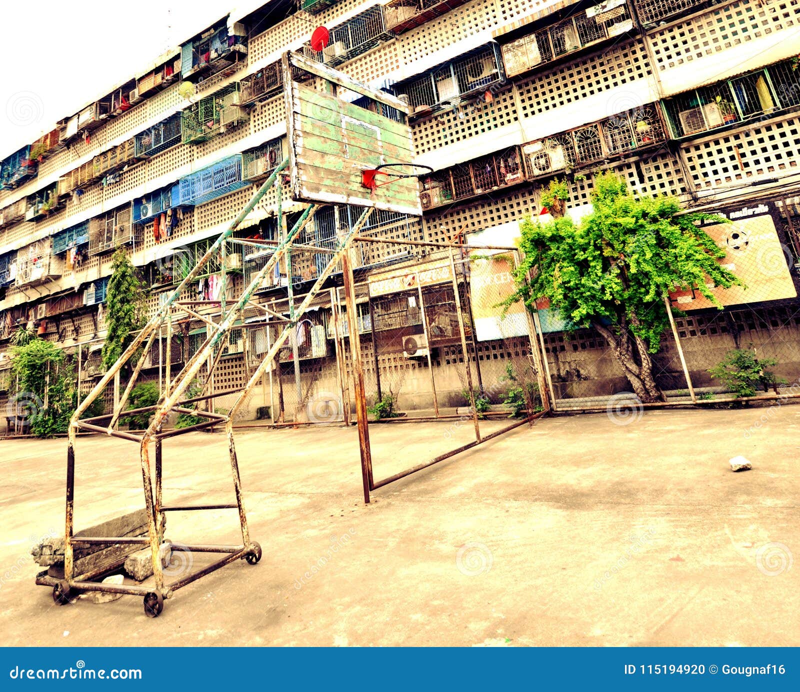 street basketball court in front of apartments bloc in bangkok, thailand.