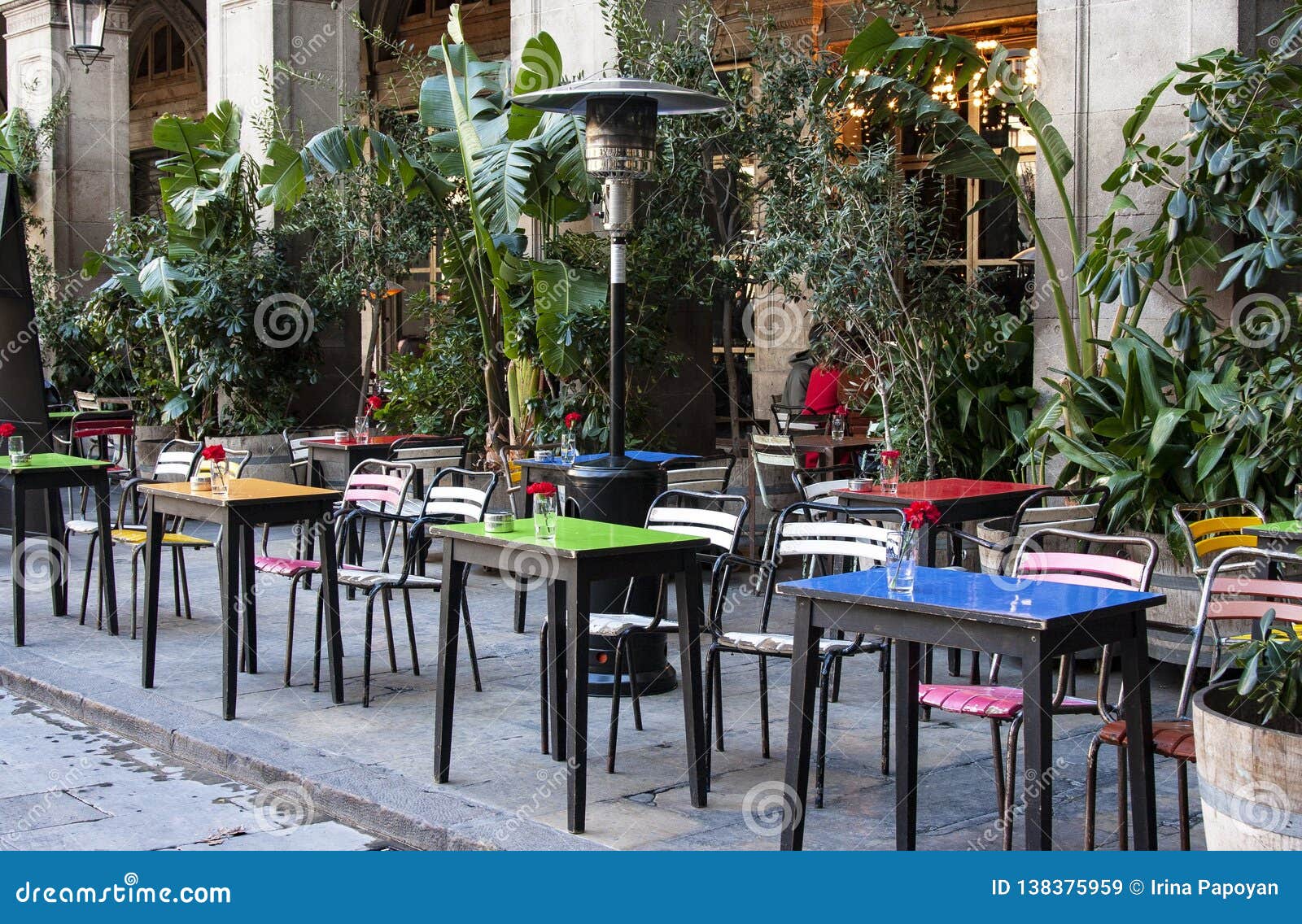 Street Cafe With Colorful Tables And Chairs In Barcelona Stock