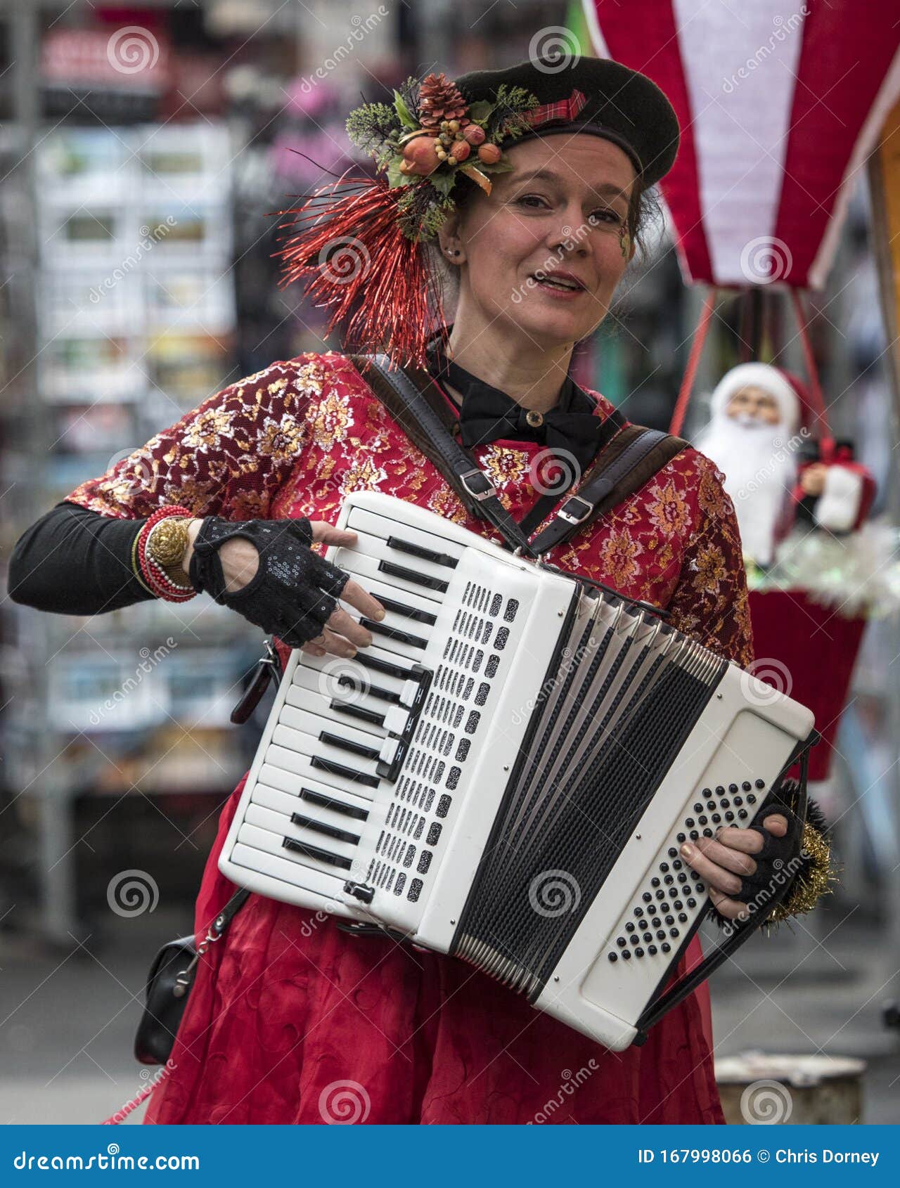 Street Entertainer in Amsterdam. Amsterdam, Netherlands - December 20th 2019: A street entertainer playing the Piano Accordion in the city of Amsterdam in the Netherlands