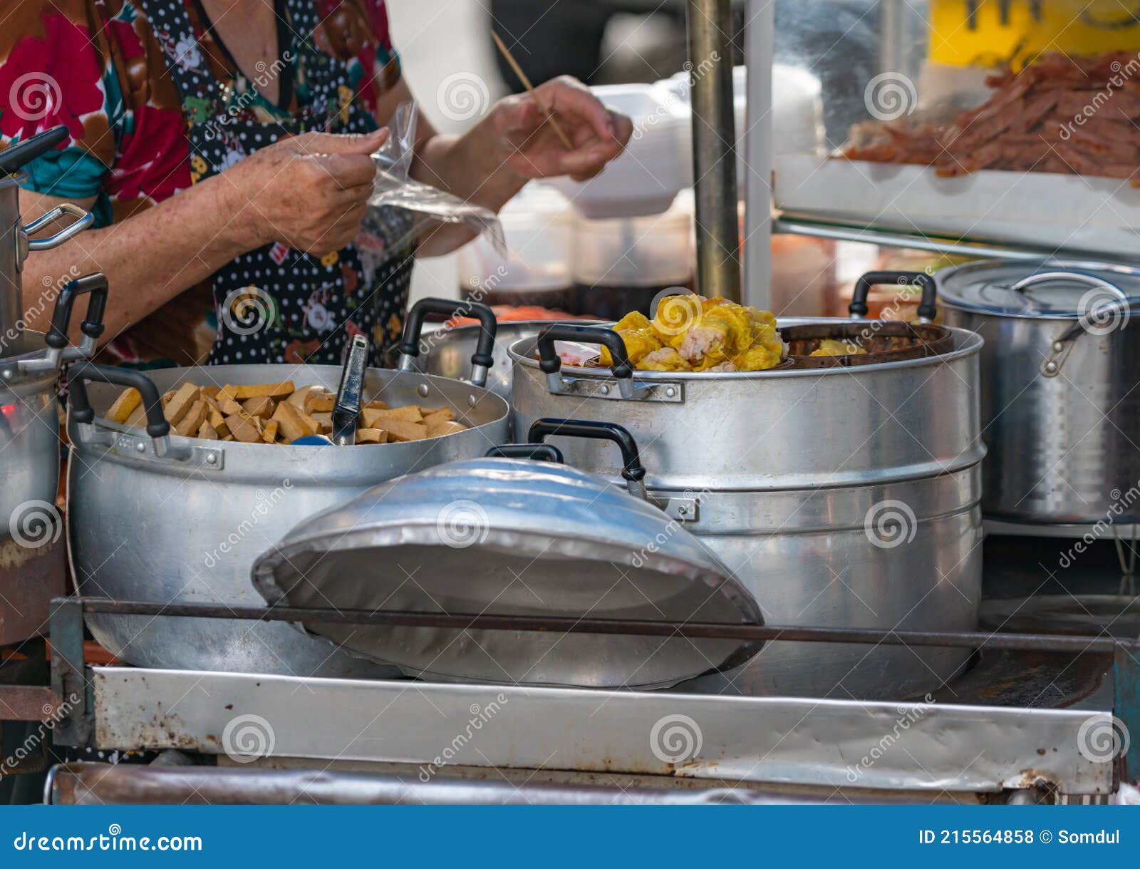 Dim Sum or Chinese dumpling in a stream hot pot of food wheelbarrow on  street food of Bangkok. Many dumpling in a wooden basket is streaming in  old As Stock Photo 