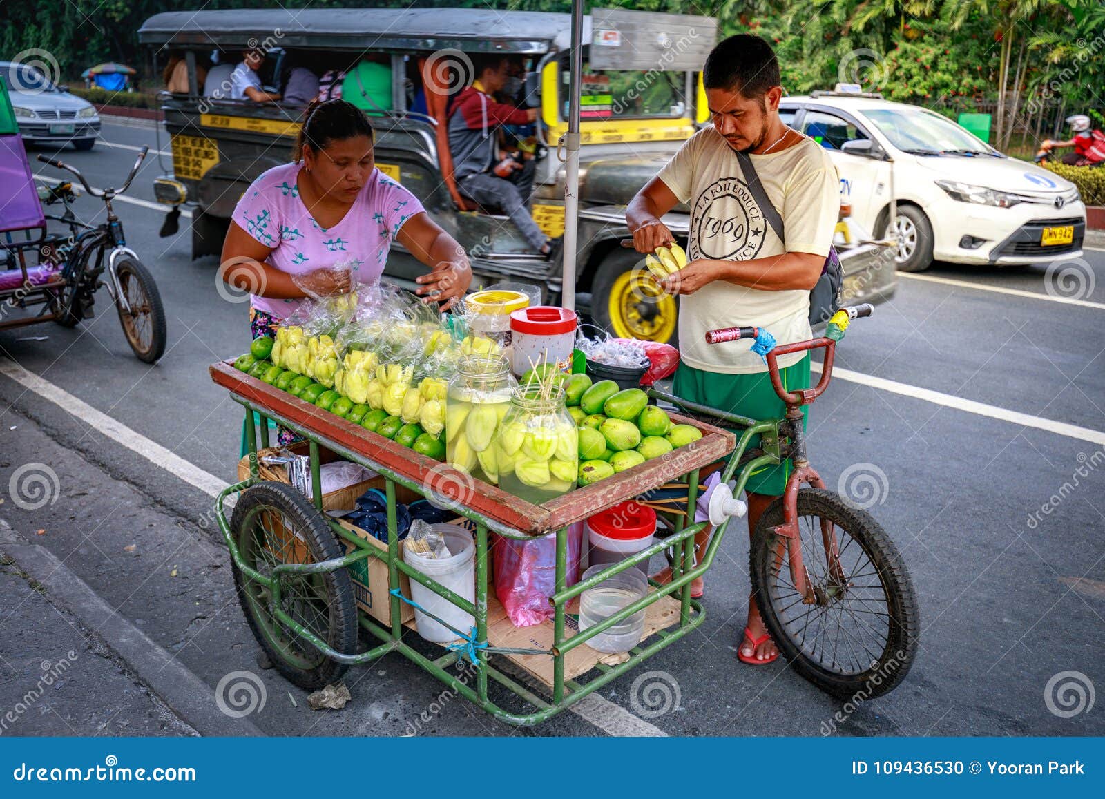 A Street Food Vendor Slices Fresh Green Mango Which Sells on Foo