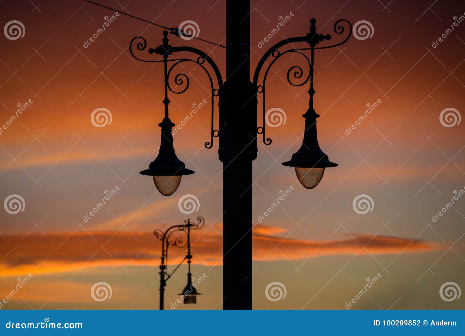 Street light at sunset stock photo. Image of bright 100209852
