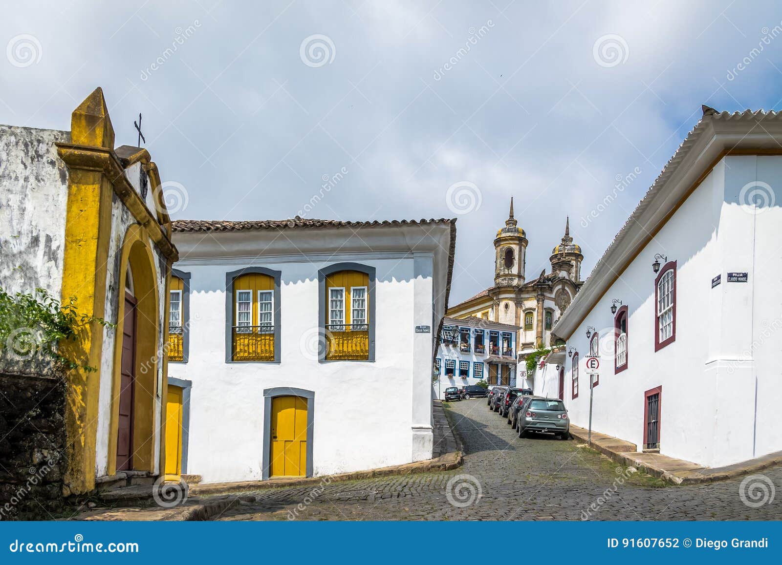 street in ouro preto city with sao francisco de assis church on backgound - ouro preto, minas gerais, brazil