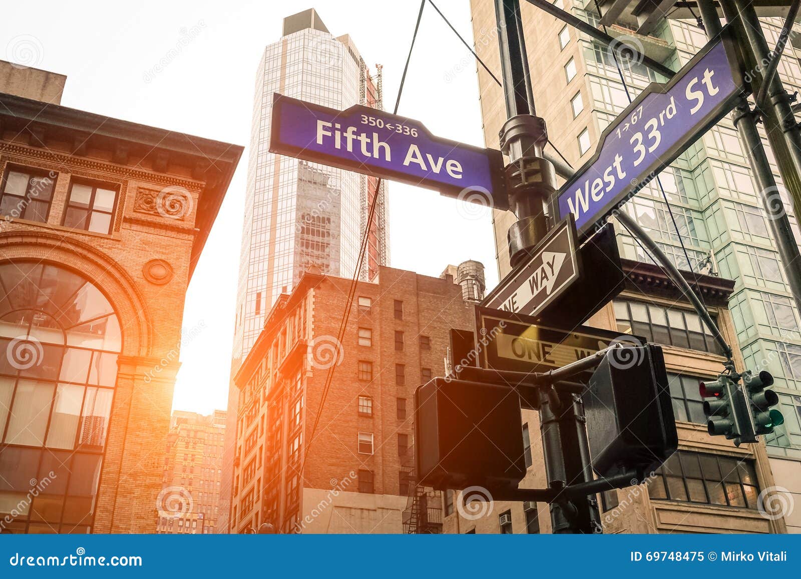 street sign of fifth ave and west 33rd st at sunset in new york