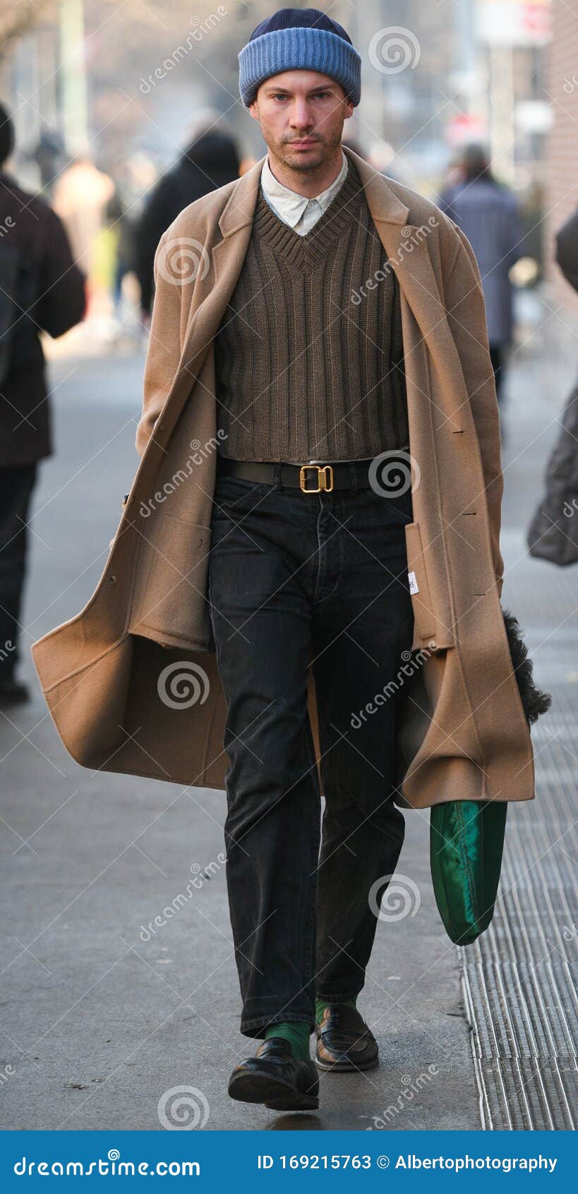 MILAN - JANUARY 15: Man with orange shirt and red Louis Vuitton Supreme bag  looking at phone before Represent fashion show, Milan Fashion Week street  Stock Photo - Alamy