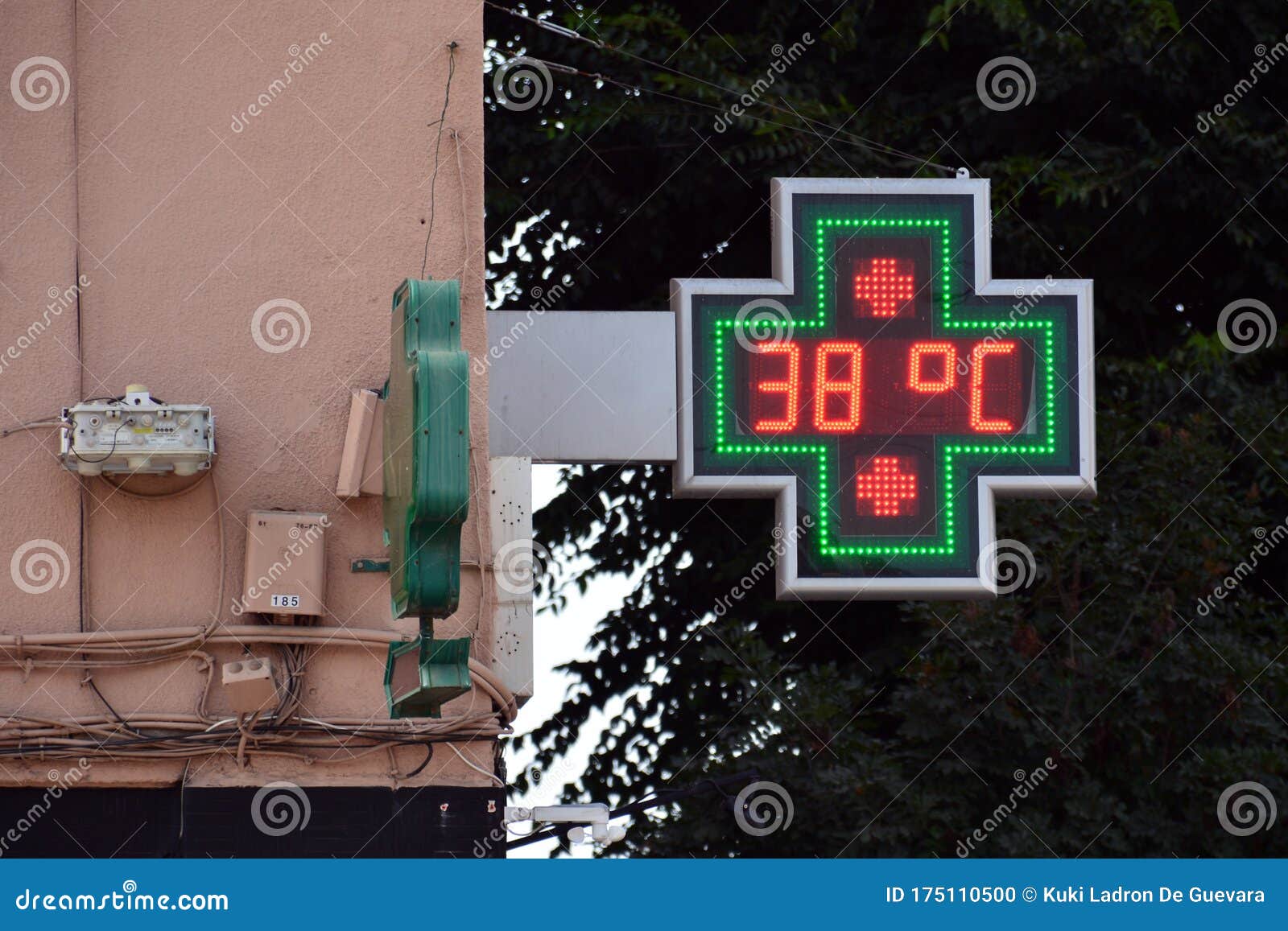 street thermometer of a pharmacy at 38 degrees celsius